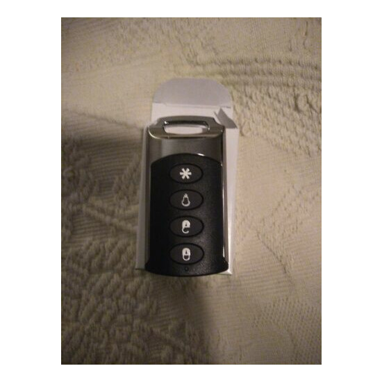 Brand New Interlogix TX-E101 Four Button Chrome Wireless Keyfob image {1}